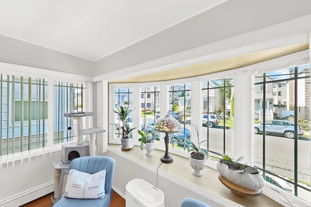 a living room with furniture a fireplace and a window