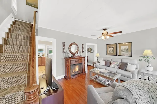 a living room with furniture a rug and a window