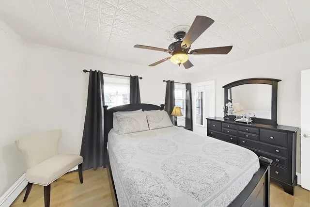 a bedroom with a large bed and a chandelier