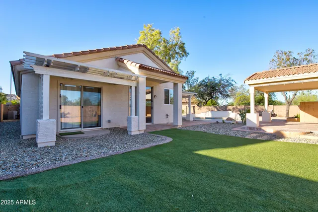 a view of a house with backyard and porch