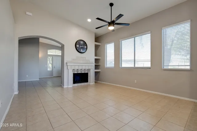 a view of a livingroom with a fireplace a window and a fireplace