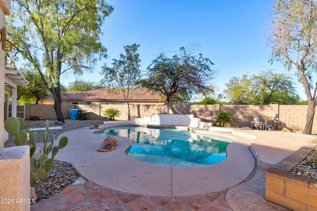 a view of a house with backyard patio and swimming pool