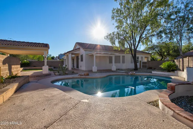 a view of a backyard with plants and a patio