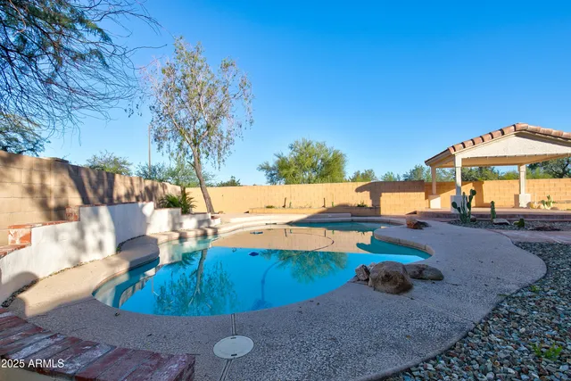 swimming pool view with a seating space