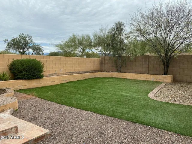 a view of a backyard with large trees