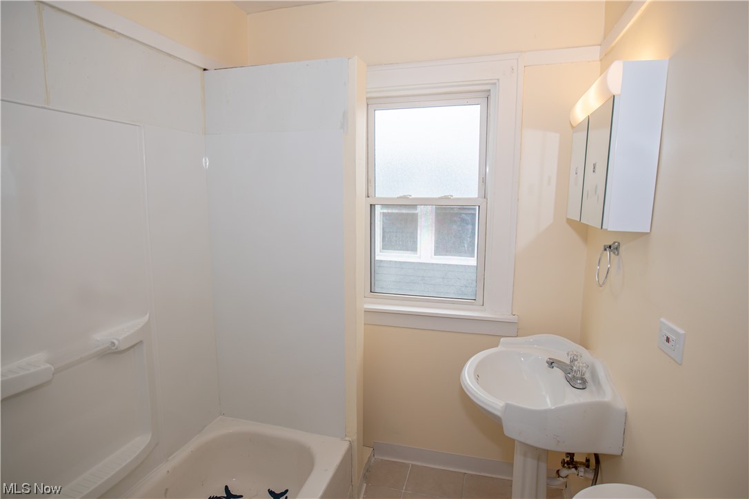16315 Nela View Road Cleveland, OH 44112 - Photo 21 of 24 Full bathroom with plenty of natural light, shower / bathtub combination, tile floors, and toilet