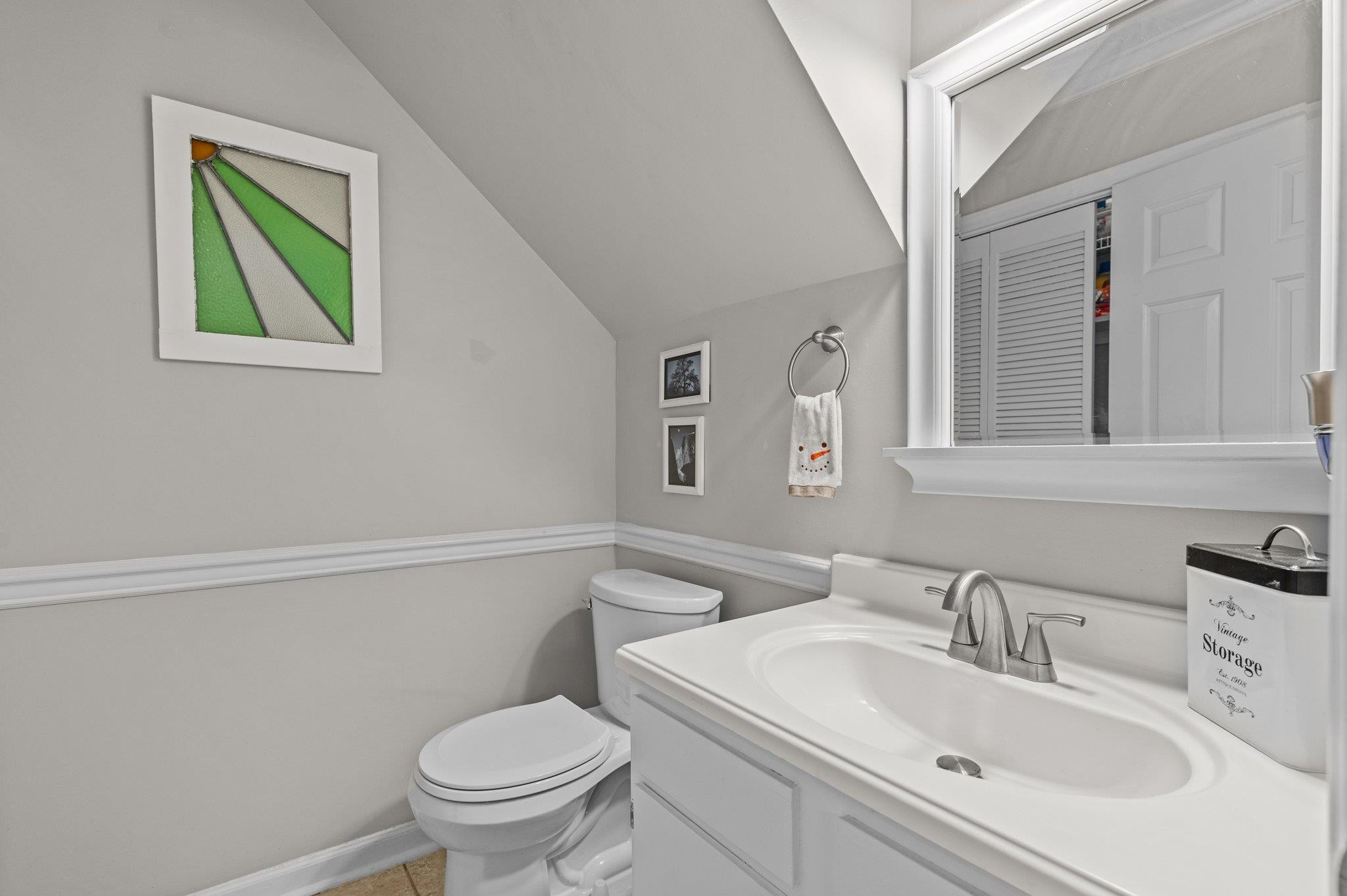 5619 Split Oak Way Raleigh, NC 27609 - Photo 14 of 36 a bathroom with a sink toilet and vanity