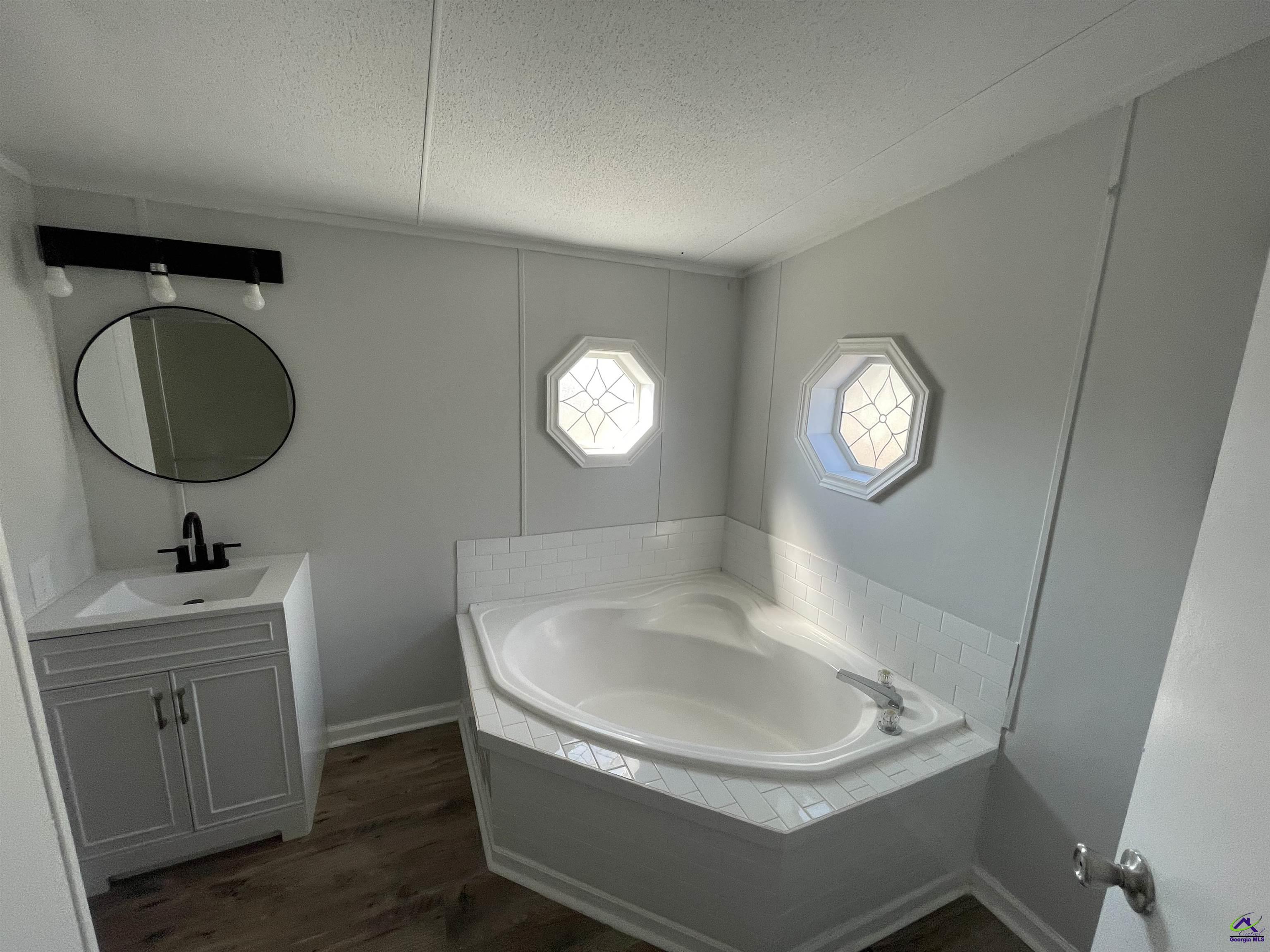 306 Dennard Road Unadilla, GA 31091 - Photo 13 of 14 a bathroom with a sink and a mirror