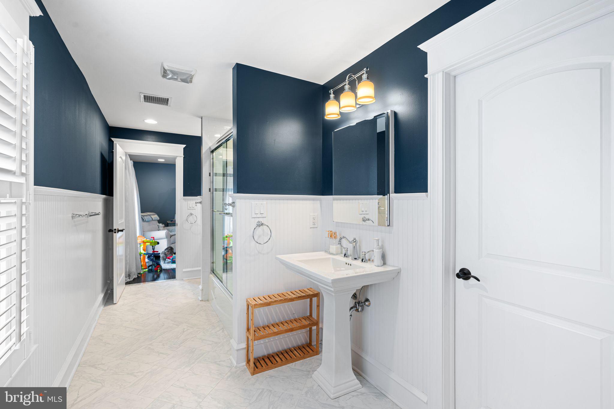 415 Washington Avenue Haddonfield, NJ 08033 - Photo 32 of 51 a bathroom with a sink and a mirror