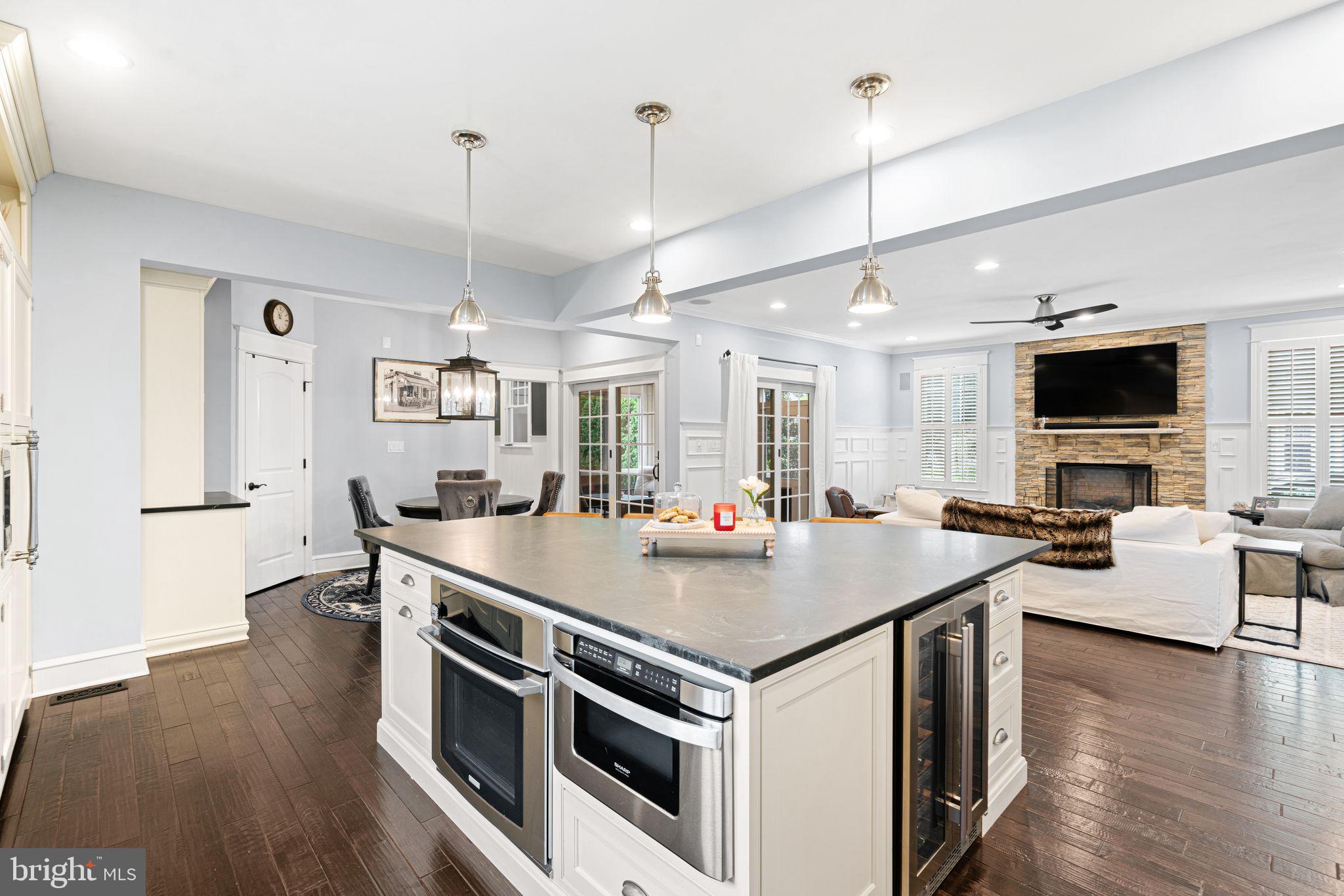415 Washington Avenue Haddonfield, NJ 08033 - Photo 8 of 51 a open kitchen with stainless steel appliances granite countertop a stove and chairs with wooden floor