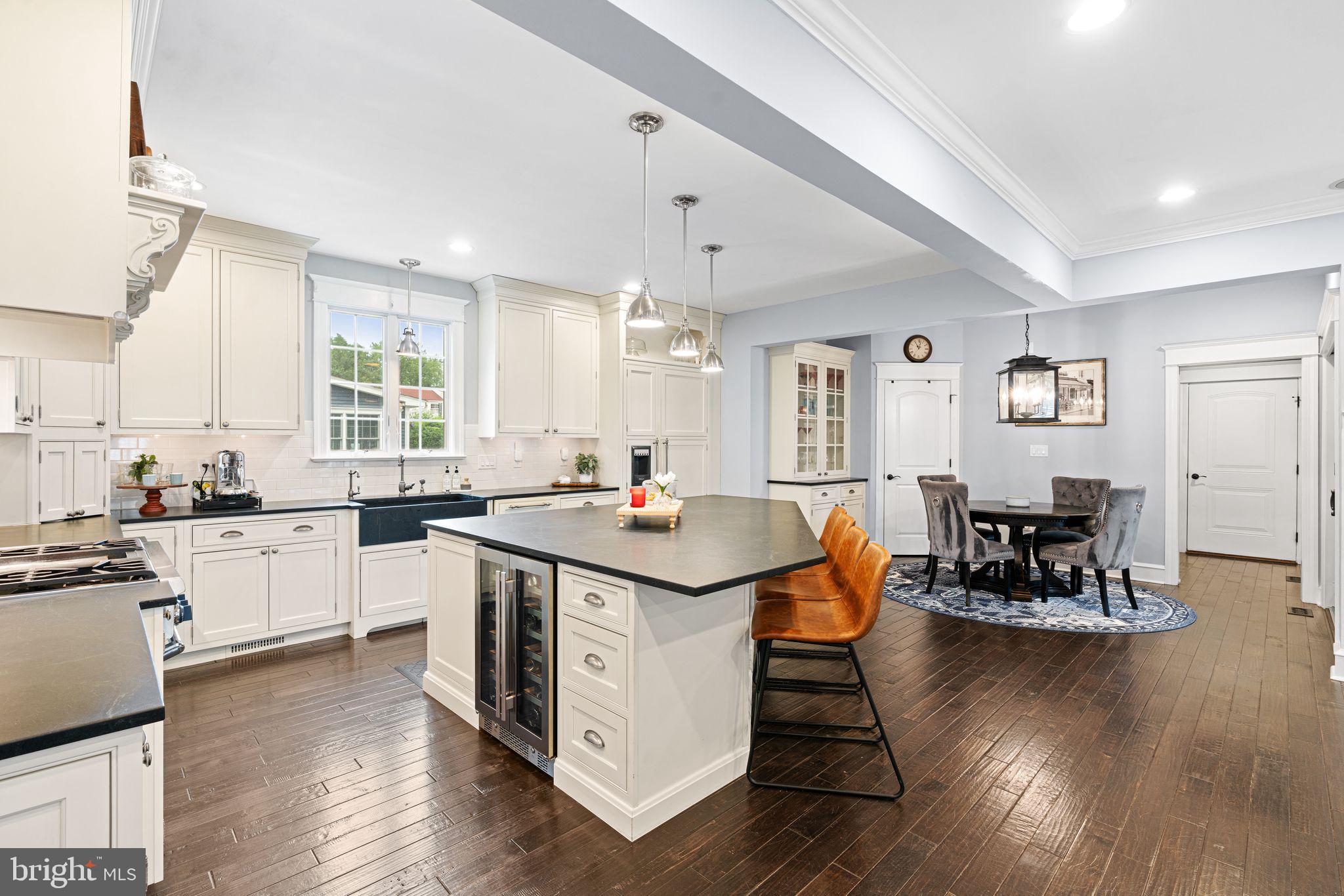 415 Washington Avenue Haddonfield, NJ 08033 - Photo 9 of 51 a kitchen with a dining table chairs and wooden floor
