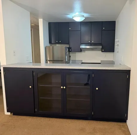 a kitchen with stainless steel appliances granite countertop a sink and a stove