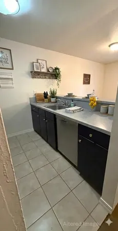 a kitchen with stainless steel appliances granite countertop a refrigerator a stove and a microwave with cabinets