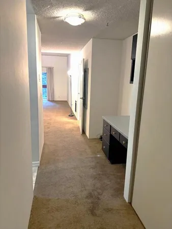 a kitchen with a refrigerator and a sink