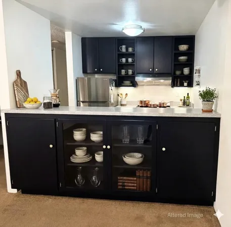 a kitchen with stainless steel appliances granite countertop wooden cabinets and sink