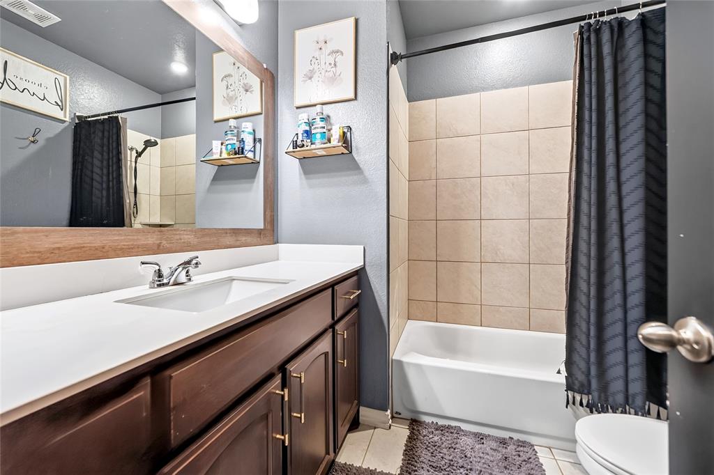 113 Ridgetop Trail Rhome, TX 76078 - Photo 20 of 32 Wood-finish vanity with an integrated sink and chrome fixtures
