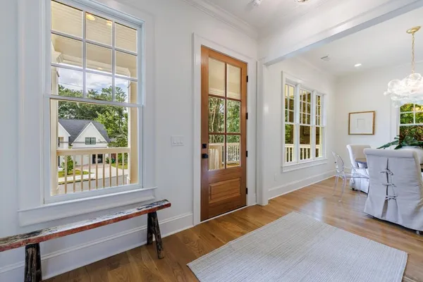 a view of entryway and hall with wooden floor