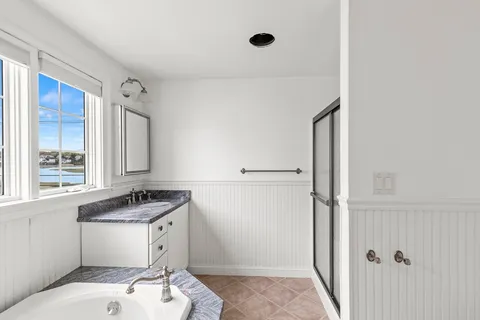 a bathroom with a sink and a granite countertop toilet