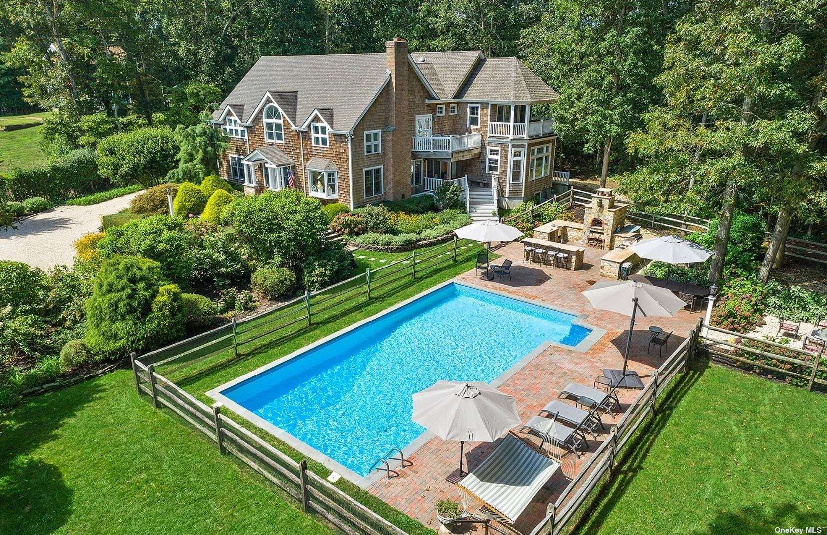 an aerial view of a house with pool