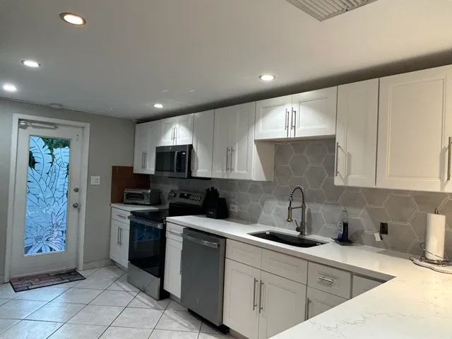 a living room with furniture a rug and a flat screen tv