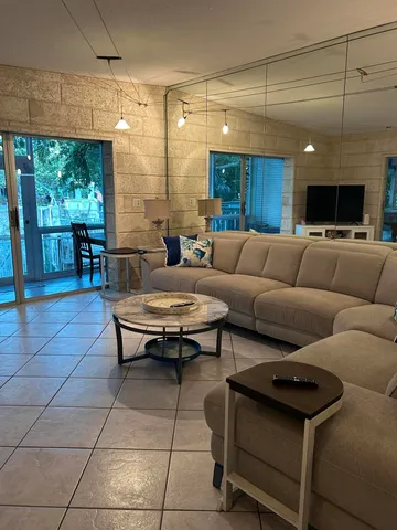 a view of a patio with dining table and chairs with a swimming pool