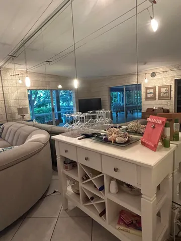 a view of a dining room and hall with furniture