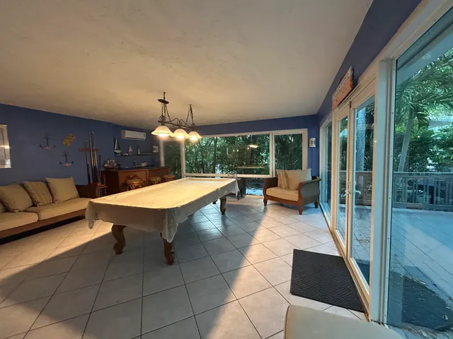 a view of a roof deck with couches and wooden floor