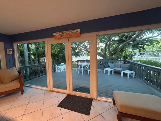 a view of a backyard with a tree and wooden fence