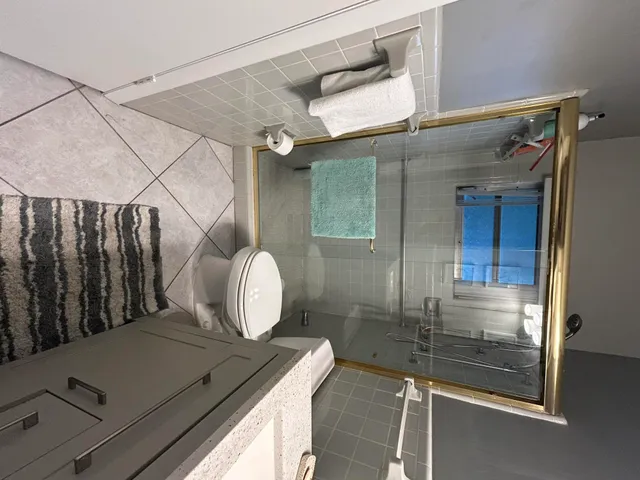 a view of a lake with a yard and large trees