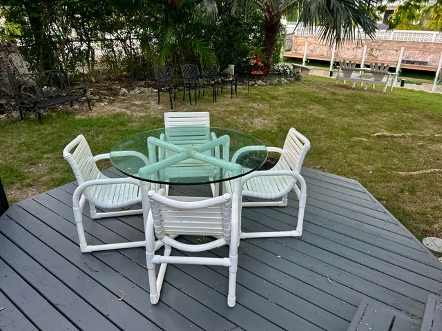 a view of a chairs in patio with a lake view