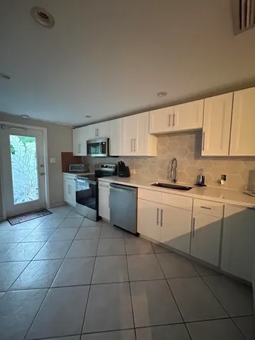 a kitchen with a table and chairs in it