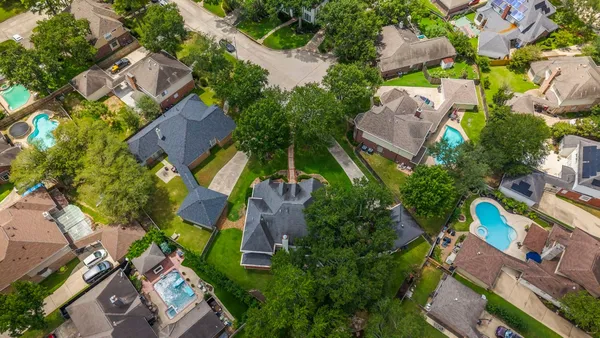an aerial view of a house with a yard and outdoor seating