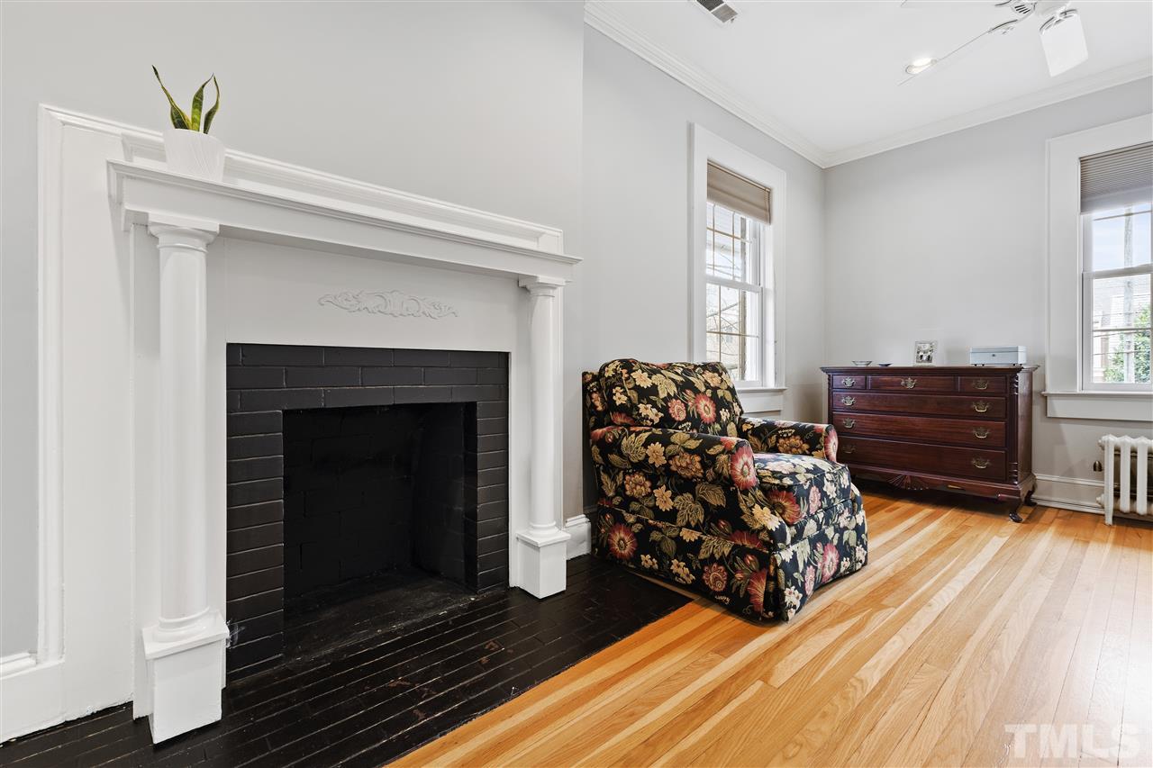 2214 Fairview Road Raleigh, NC 27608 - Photo 14 of 25 a bed room with furniture and a fireplace