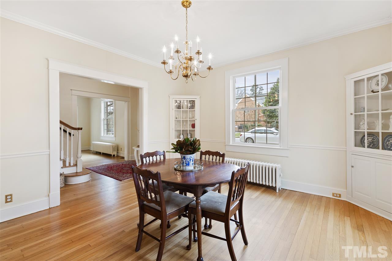 2214 Fairview Road Raleigh, NC 27608 - Photo 5 of 25 a view of a dining room with furniture wooden floor and chandelier