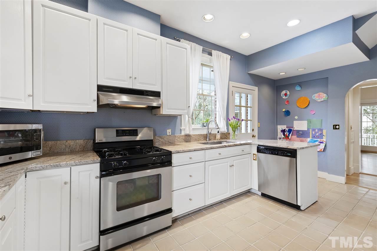 2214 Fairview Road Raleigh, NC 27608 - Photo 7 of 25 a kitchen with stainless steel appliances granite countertop a stove a sink and a microwave