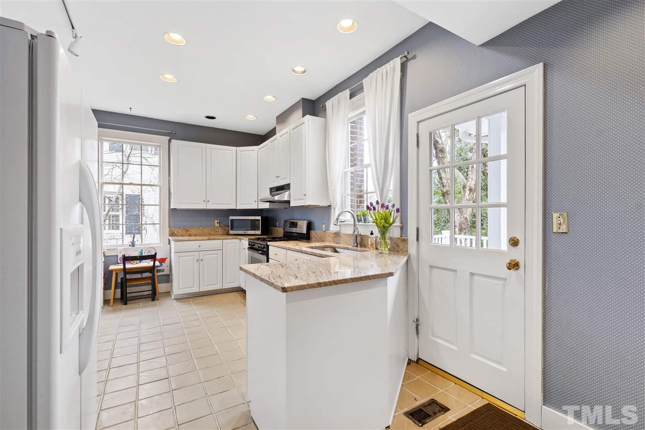2214 Fairview Road Raleigh, NC 27608 - Photo 10 of 25 a kitchen with appliances cabinets and a counter top space