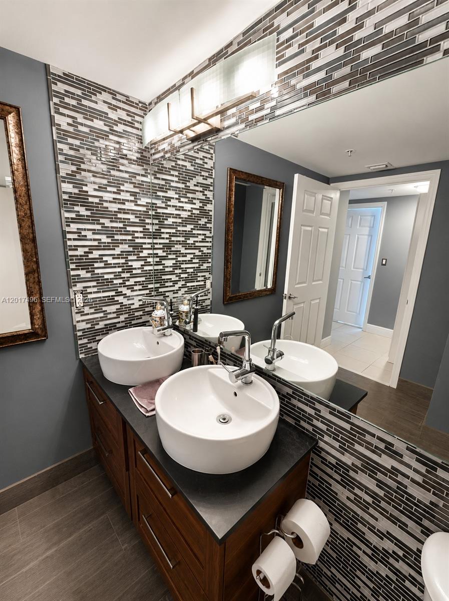 Brickell Miami, FL 33131 - Photo 12 of 19 a view of a bathroom with a sink and mirror