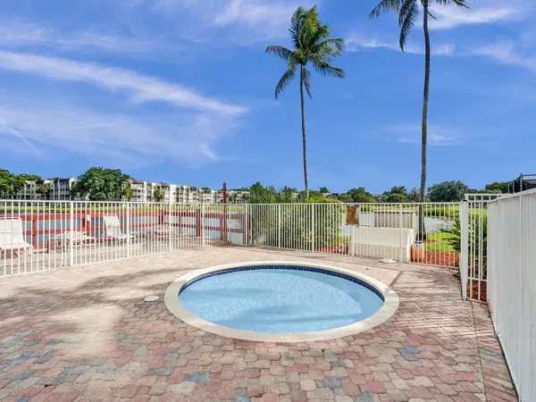 a view of a swimming pool with a table and chairs