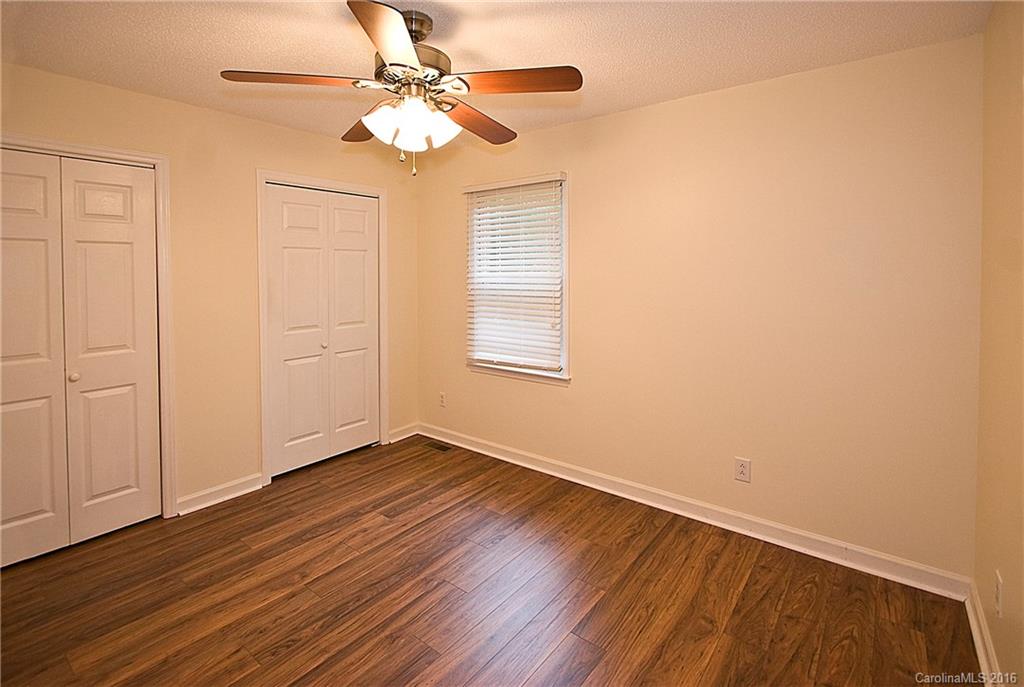 9505 Mini Ranch Road Waxhaw, NC 28173 - Photo 15 of 24 a view of an empty room with wooden floor and a fan