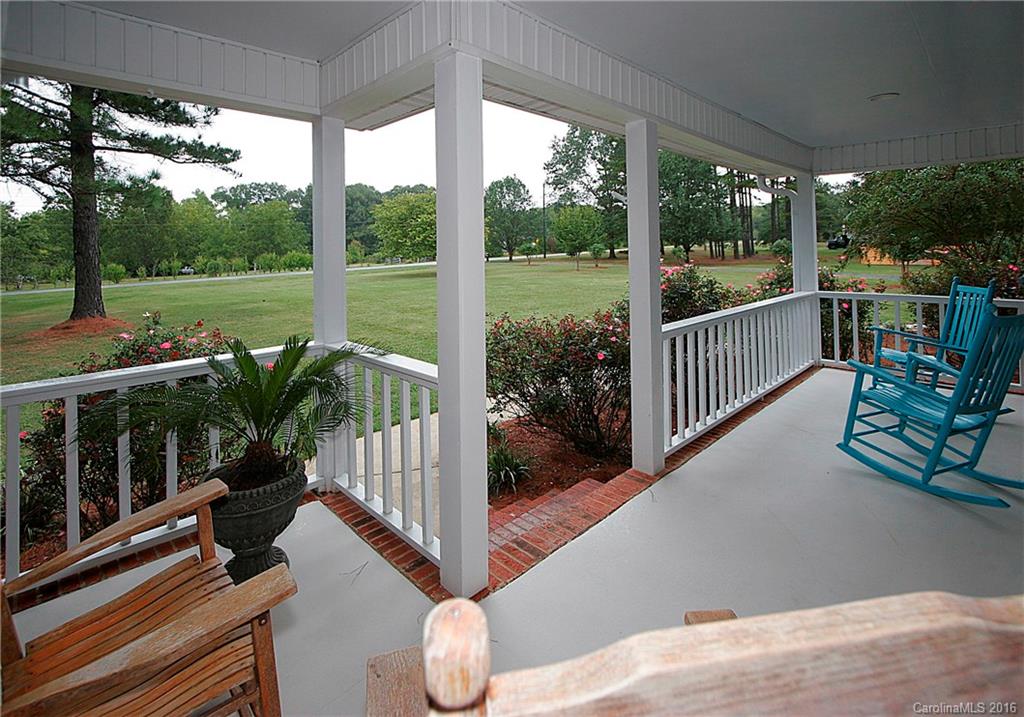 9505 Mini Ranch Road Waxhaw, NC 28173 - Photo 3 of 24 a view of a chair and tables in the balcony