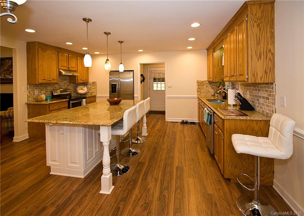 9505 Mini Ranch Road Waxhaw, NC 28173 - Photo 8 of 24 a kitchen with a table chairs refrigerator and wooden floor
