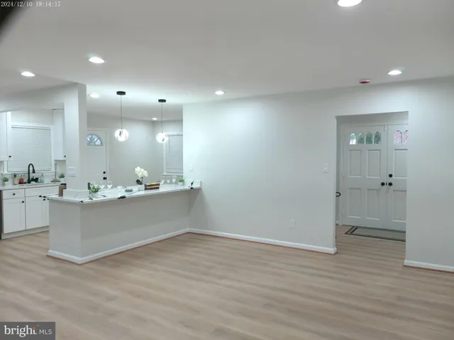 a view of a small space with wooden floor and a window