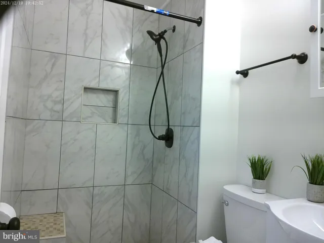 a view of an entryway with wooden floor and staircase