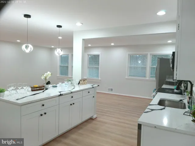 a kitchen with stainless steel appliances granite countertop a refrigerator sink and stove