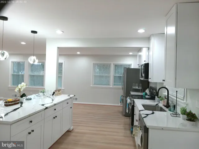 a kitchen with a sink stove and refrigerator