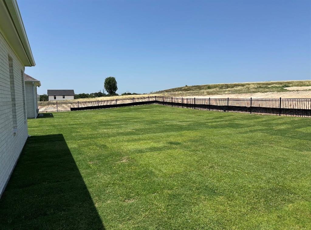 3006 Wheeler Branch Road Granbury, TX 76049 - Photo 28 of 29 Expansive green lawn bounded by a black metal fence