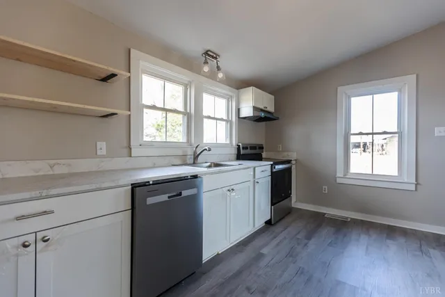 a kitchen with sink cabinets and wooden floor