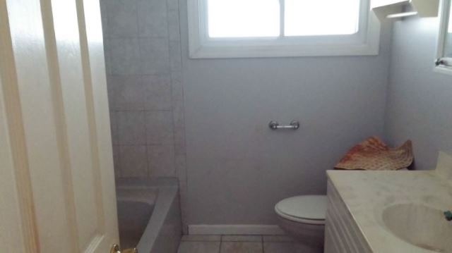 1021 Highmoor Road Lombard, IL 60148 - Photo 4 of 16 a white toilet sitting next to a sink
