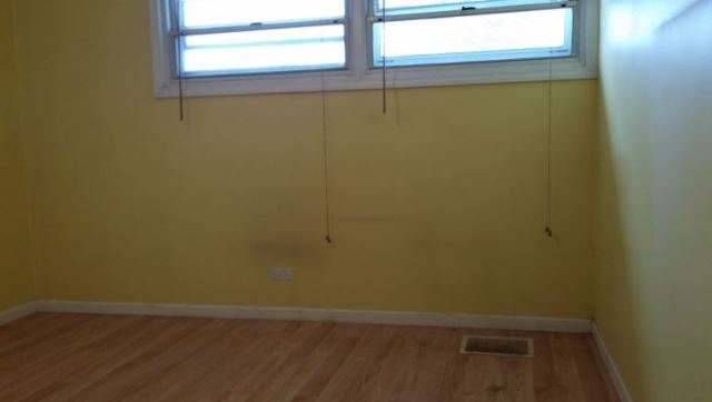 1021 Highmoor Road Lombard, IL 60148 - Photo 5 of 16 a view of a small space with wooden floor and a window