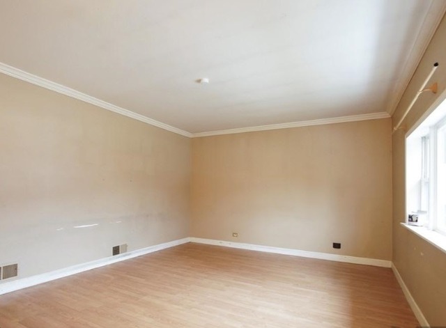 1021 Highmoor Road Lombard, IL 60148 - Photo 8 of 16 wooden floor in an empty room with a window